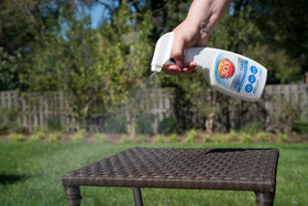 303 Products bottle beside common objects showing 16 oz size and portability