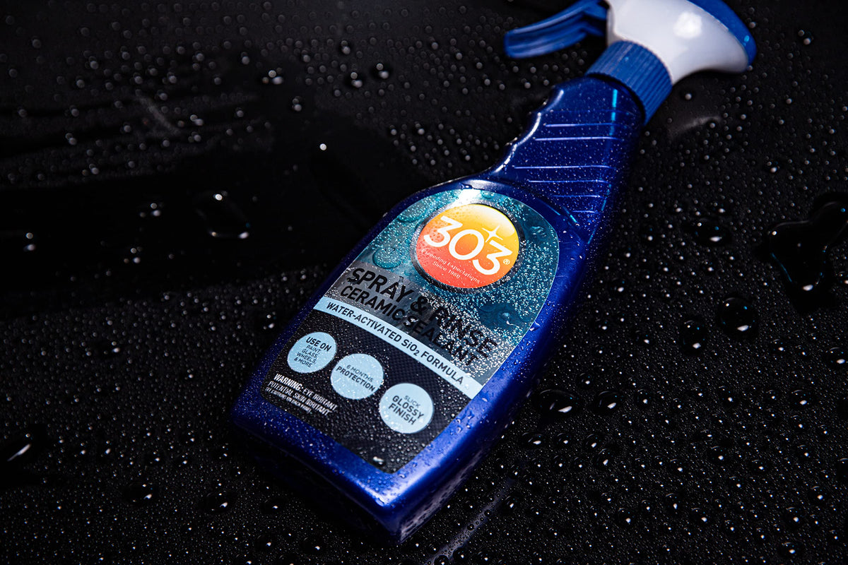 303 Products bottle staged near a clean car to suggest convenient maintenance