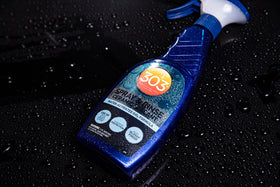 303 Products bottle staged near a clean car to suggest convenient maintenance