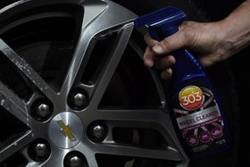 303 Products bottle in hand for size scale showing compact 15.5 fl oz convenience