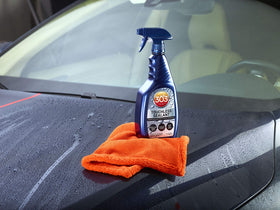 303 bottle next to microfiber showing size and coverage per bottle