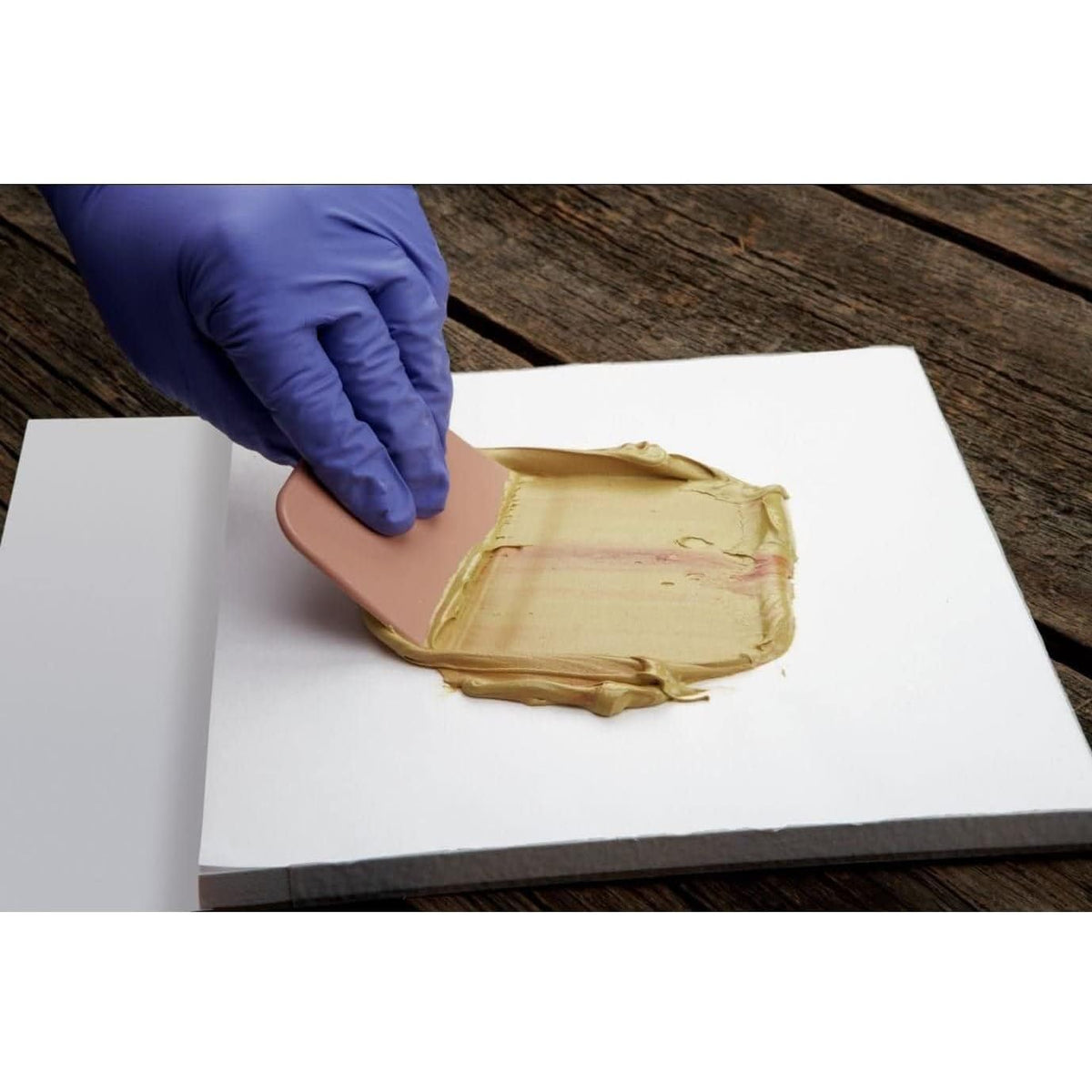 3M Bondo spreader in use on car panel demonstrating smooth filler application