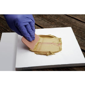 3M Bondo spreader in use on car panel demonstrating smooth filler application