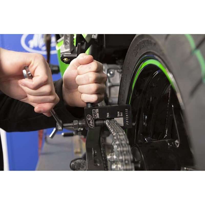 4into1 Motion Pro tool in use pressing a motorcycle chain for precise maintenance