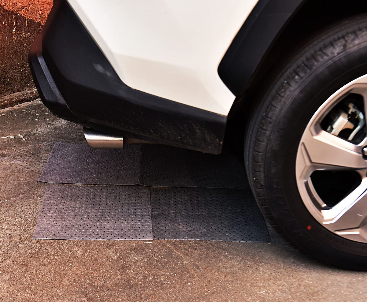 A A IN in use on a garage floor containing motor oil spill and improving safety