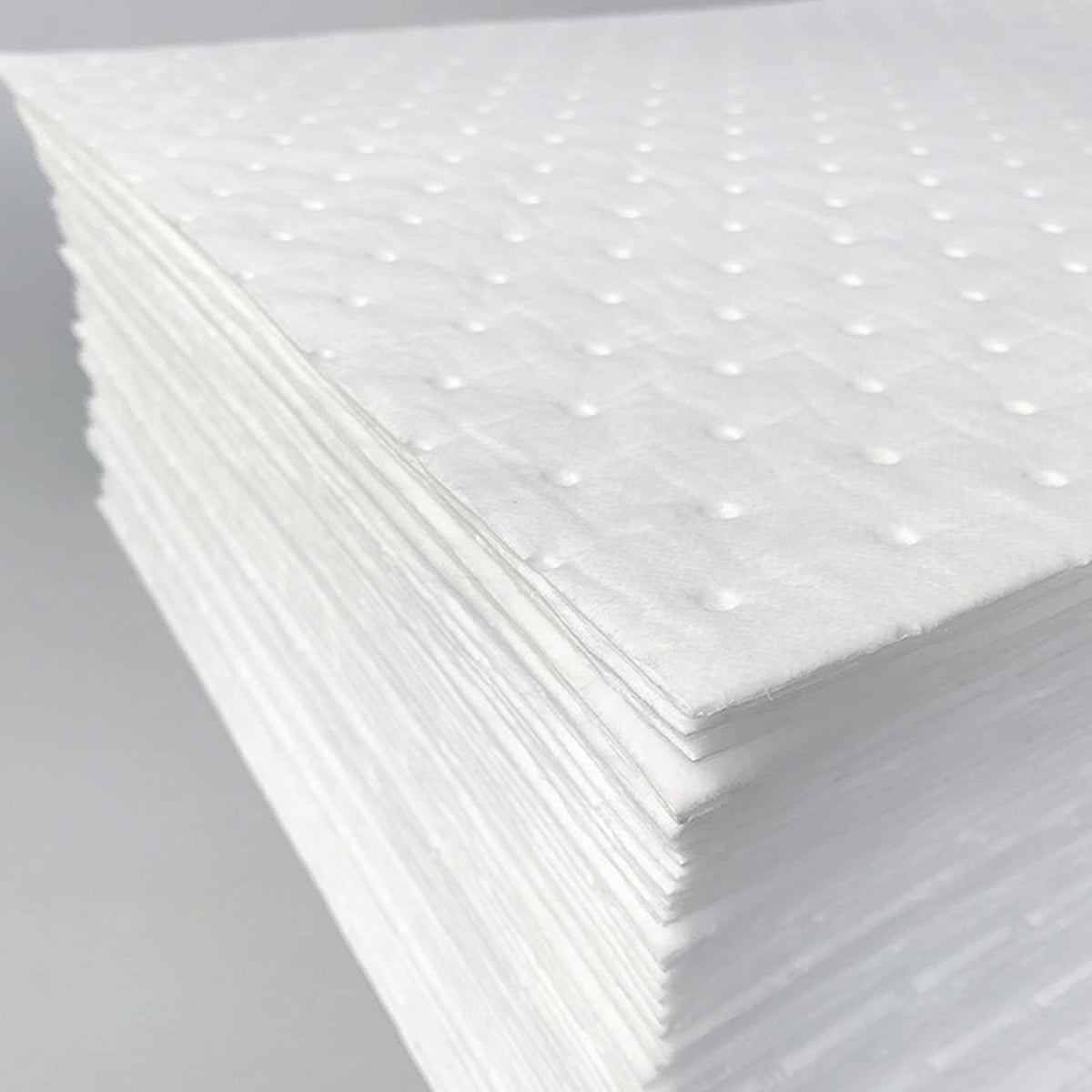 A A IN pad absorbing engine oil demonstrating quick uptake benefit