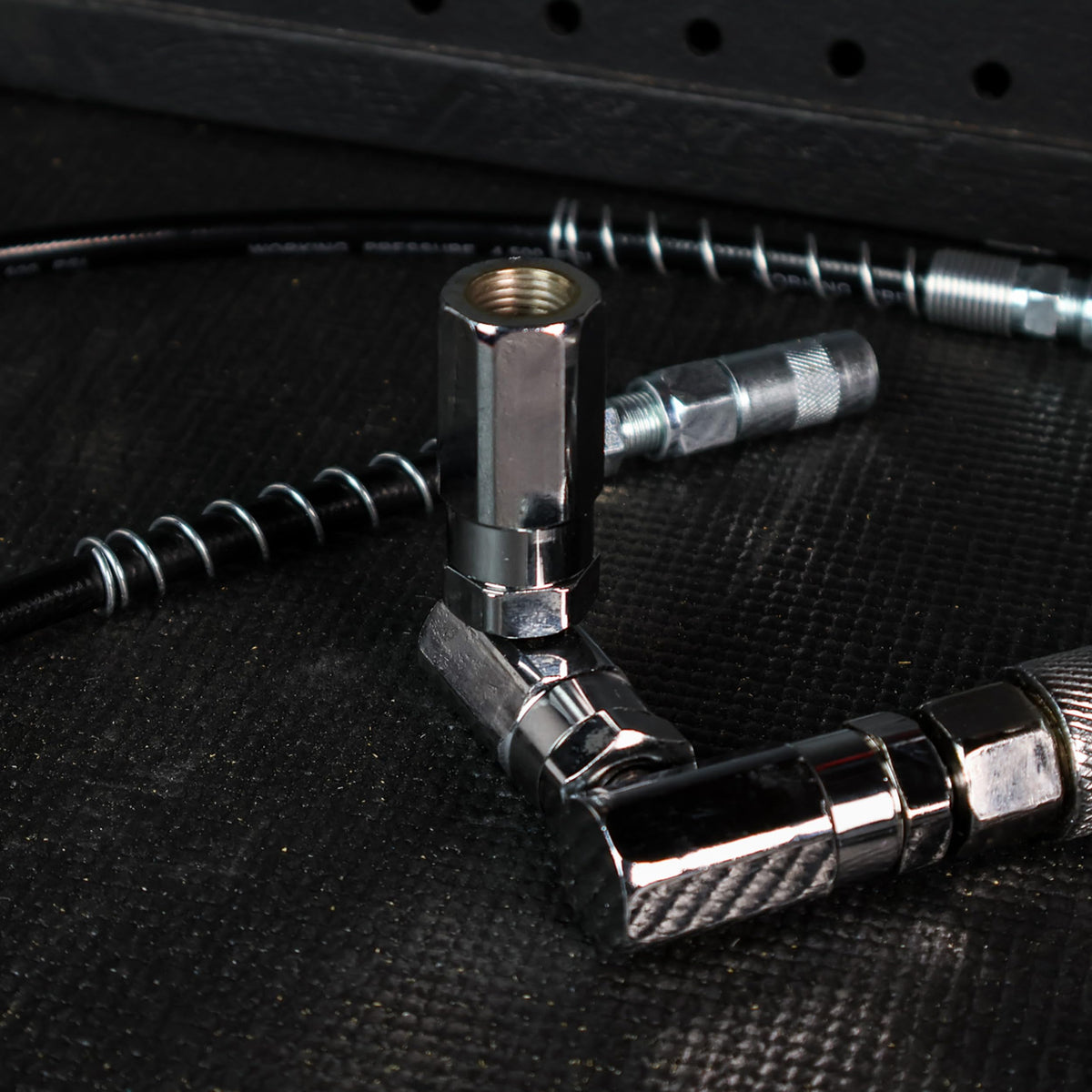 ABN 4-jaw coupler engaged on grease nipple ensuring secure seal and leak reduction