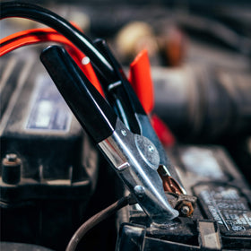 ABN jumper cables in use between two cars demonstrating long reach benefit