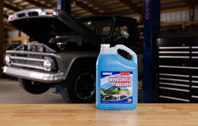 ABRO one-gallon bottles stored on a garage shelf for convenient access