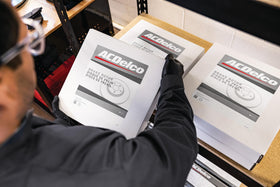 ACDelco rotor beside tape measure showing size for accurate vehicle match