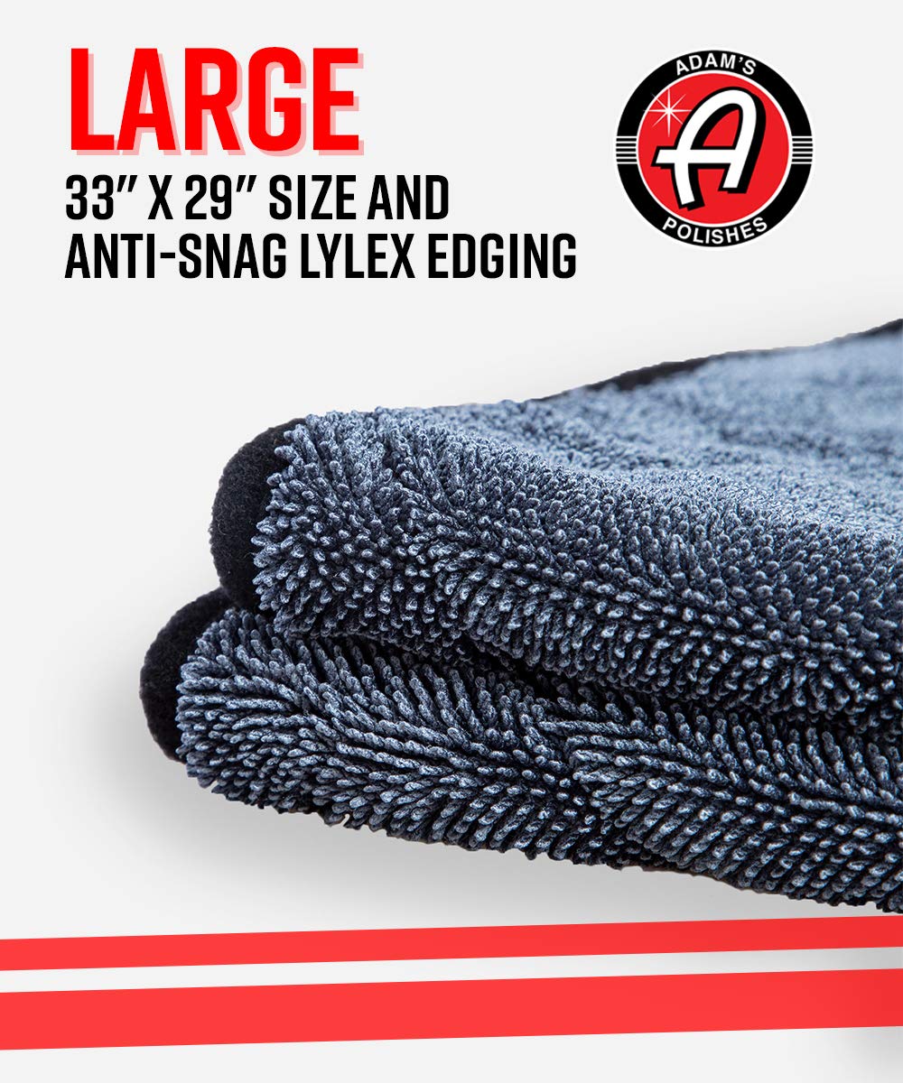 Adam's Polishes towel beside hand and car key to illustrate 33x29 inch size and coverage