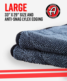 Adam's Polishes towel beside hand and car key to illustrate 33x29 inch size and coverage