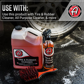 Adam's Polishes brush staged with cleaners in a detailing setup for efficient workflow