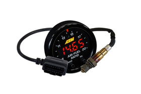 AEM gauge next to ruler showing 52mm diameter for accurate size comparison