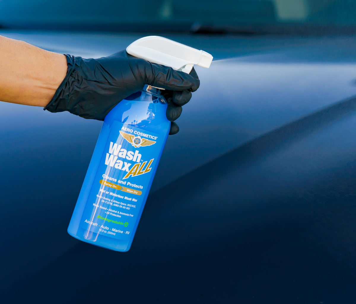 Aero Cosmetics being sprayed onto a wet car door showing safe wash-as-you-dry use