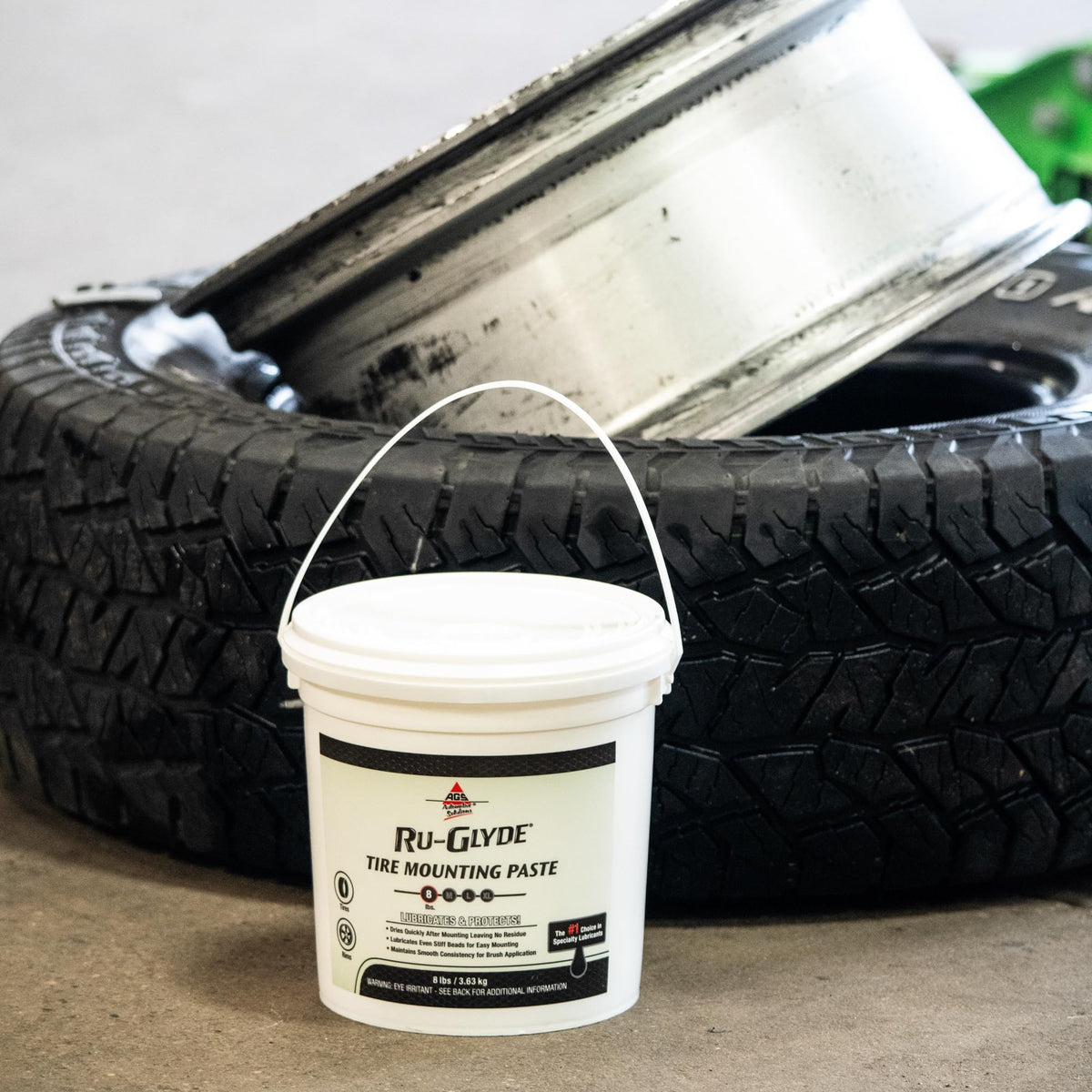 AGS Ru-Glyde 8 lb pail beside a tape measure for clear size comparison