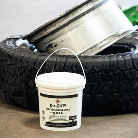 AGS Ru-Glyde 8 lb pail beside a tape measure for clear size comparison