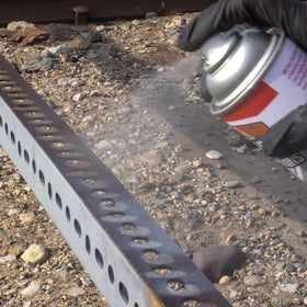 AGS RUST SOLUTIONS being sprayed on a metal railing showing fast rust arrest benefit