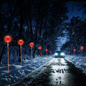 AHKUNMT markers along snowy driveway guiding vehicle and plow safe passage