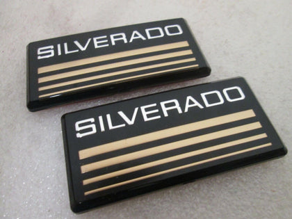 Aimoll front view of two yellow Silverado emblems showing clean packaging and ready-to-stick benefit