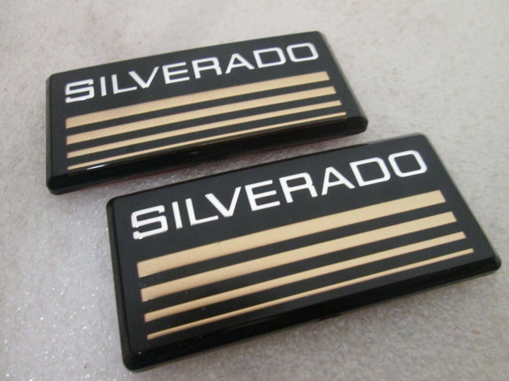 Aimoll front view of two yellow Silverado emblems showing clean packaging and ready-to-stick benefit