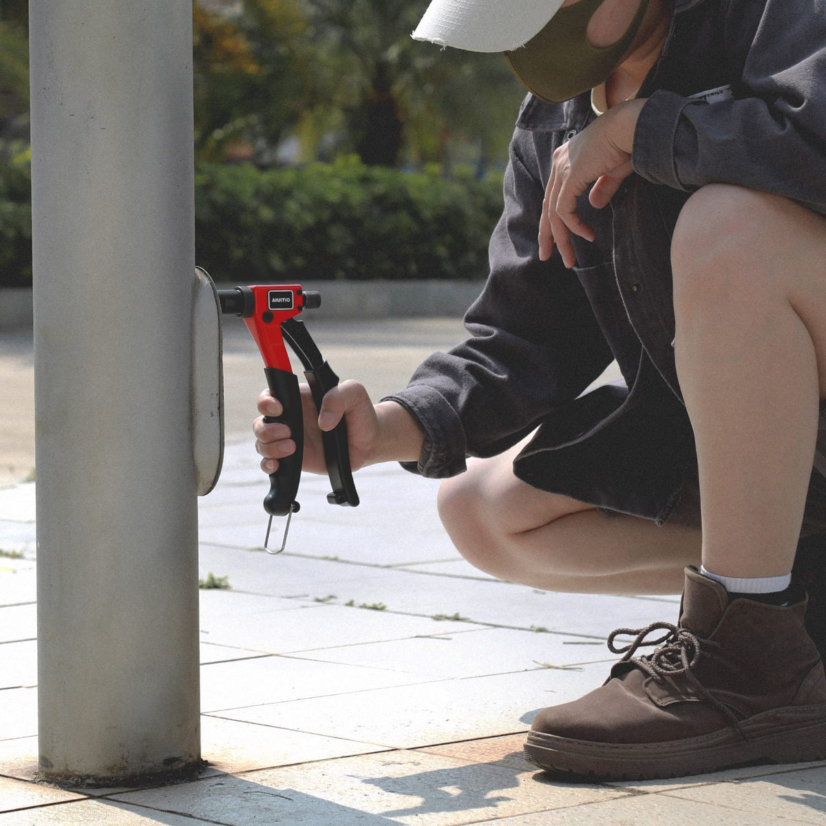 AIUITIO beside ruler for scale showing compact size and clearance benefit