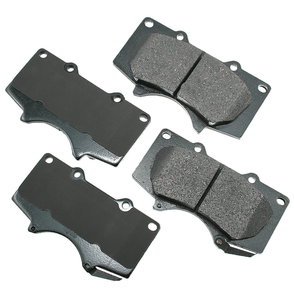 Akebono front brake pad set showing pads and backing plate for quiet braking