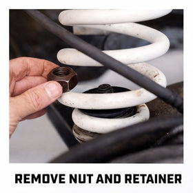 Alltrade Powerbuilt tool in use compressing a strut, demonstrating secure spring control