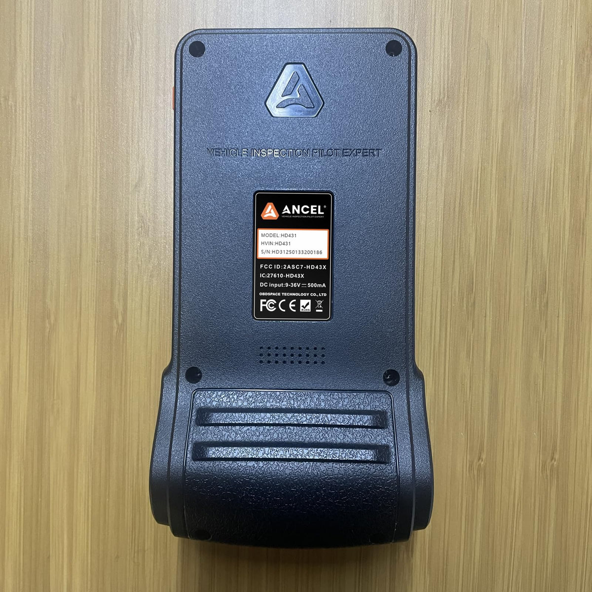 ANCEL HD431 next to a handheld tool for scale, compact portability benefit