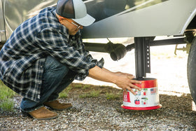 Andersen Hitches scale comparison with hand showing compact transport convenience
