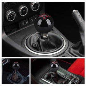 Scale comparison of ANDO RACING knob next to a ruler, showing compact size for ergonomic handling