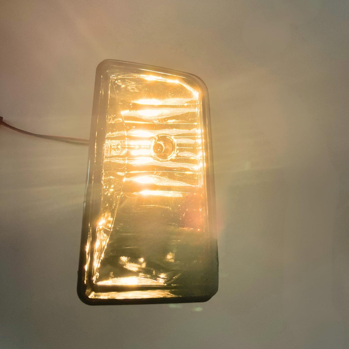 AniyaFDCX fog lamp next to ruler showing compact size and correct scale