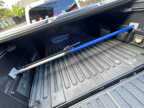 ANLU LOAD beside a ruler to show adjustable 44 to 74 inch range