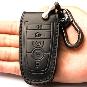APEKUU key shell with attached leather keychain held in hand for easy carry