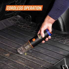 Armor All vacuum in car seat crevice removing crumbs for easier interior maintenance
