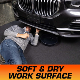 Armor All mat in use under car protecting garage floor