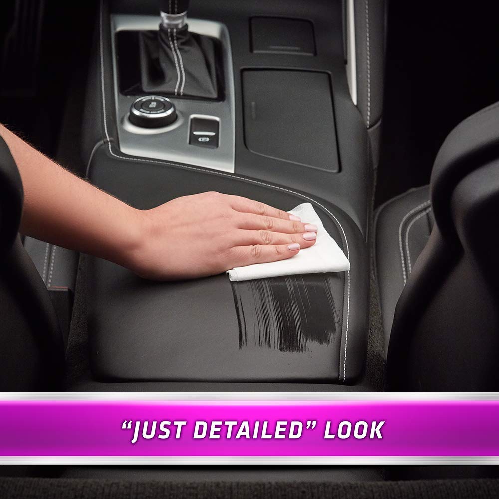 Armor All wipe being used on a car dashboard to remove grime and freshen interior quickly