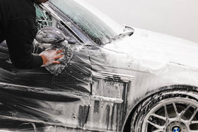 Armour Detail Supply product in use washing car in a driveway setting