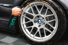 Armour Detail Supply spray applying cleaner to wheel spokes to loosen grime and brake dust