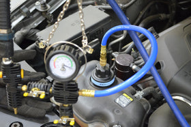 Astro Pneumatic universal vacuum adapter attached to radiator neck for faster coolant refill benefit
