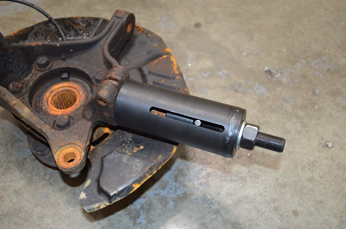 Astro Pneumatic tool in use on Subaru suspension showing faster extraction benefit