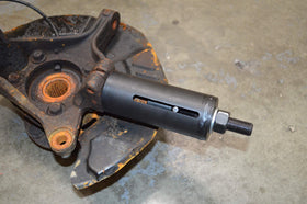 Astro Pneumatic tool in use on Subaru suspension showing faster extraction benefit