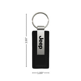 AU-TOMOTIVE GOLD key fob on a Jeep dashboard conveying branded lifestyle appeal