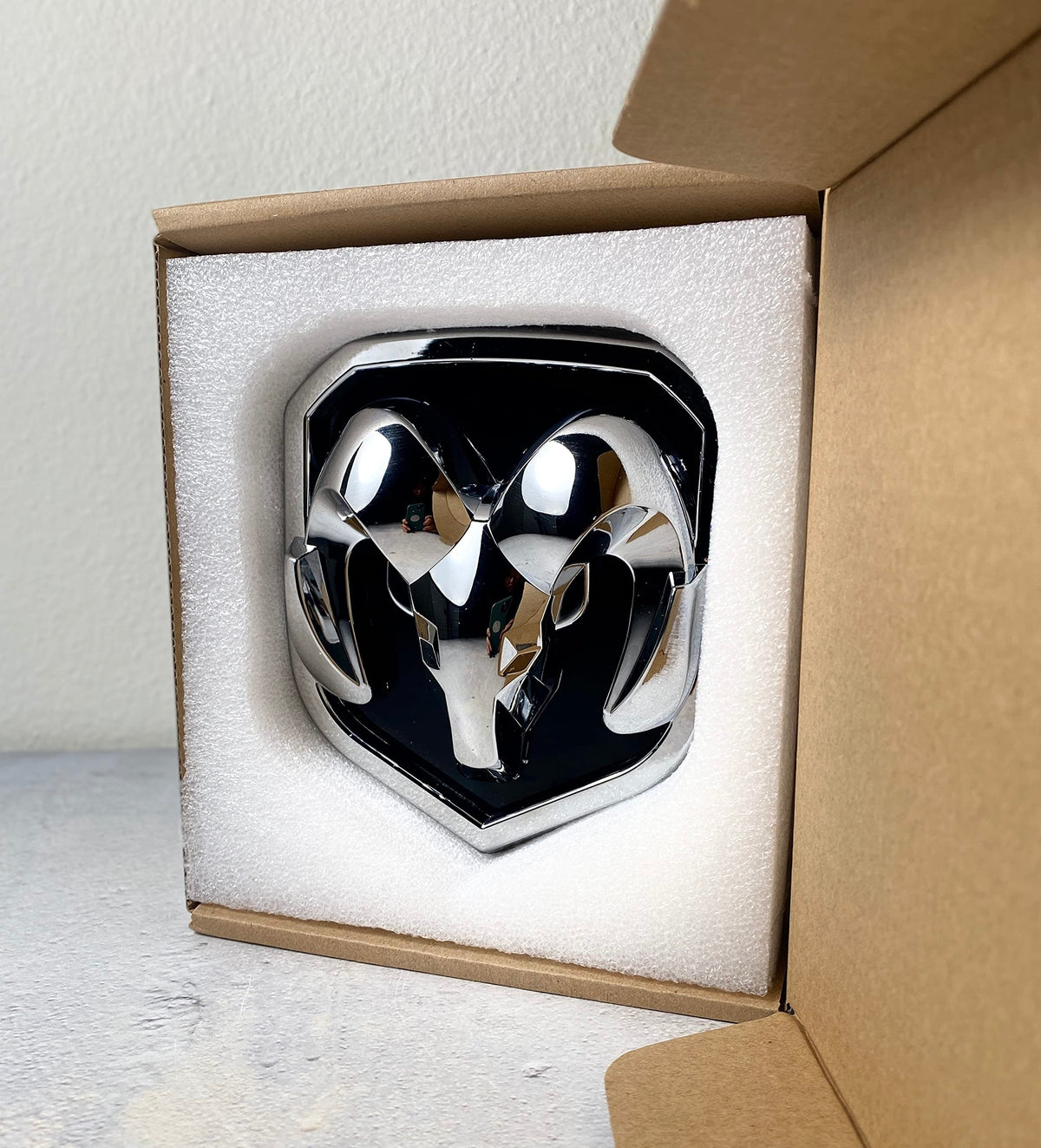 Autogem chrome RAM emblem installed on truck grille showing improved appearance