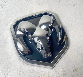 Autogem chrome RAM emblem held in hand to show scale and precise fitment