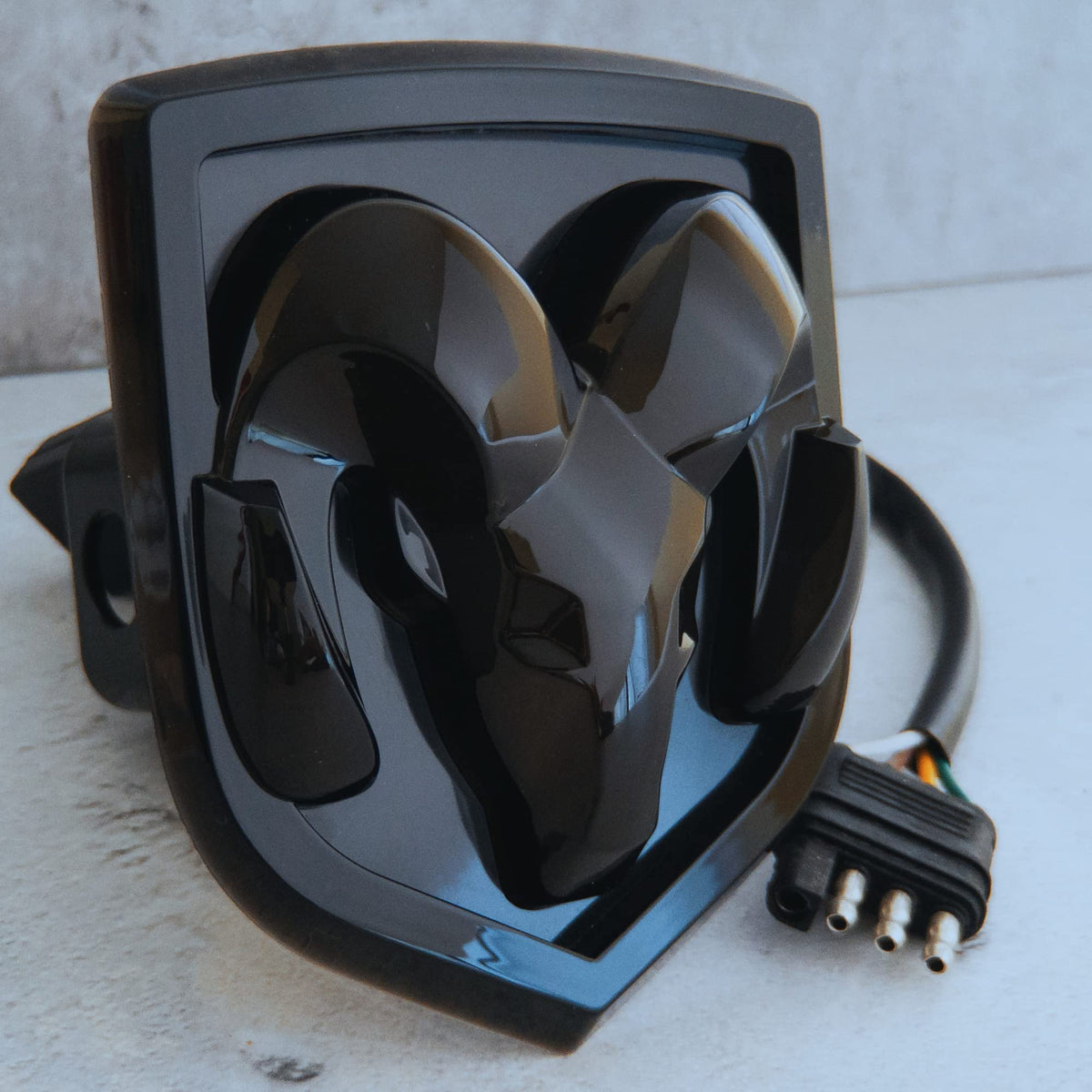 Autogem front view of hitch cover showing illuminated RAM logo and improved visibility