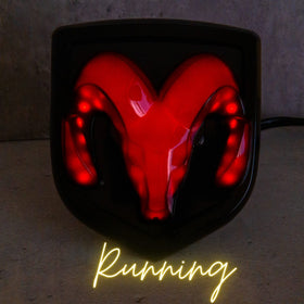 Autogem close-up of RAM logo where red LEDs shine through metalized finish