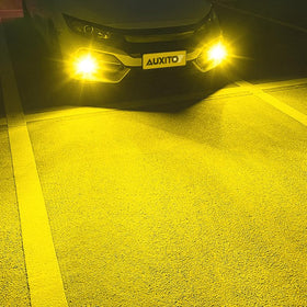 AUXITO next to standard OEM bulb for size comparison and direct fit reassurance
