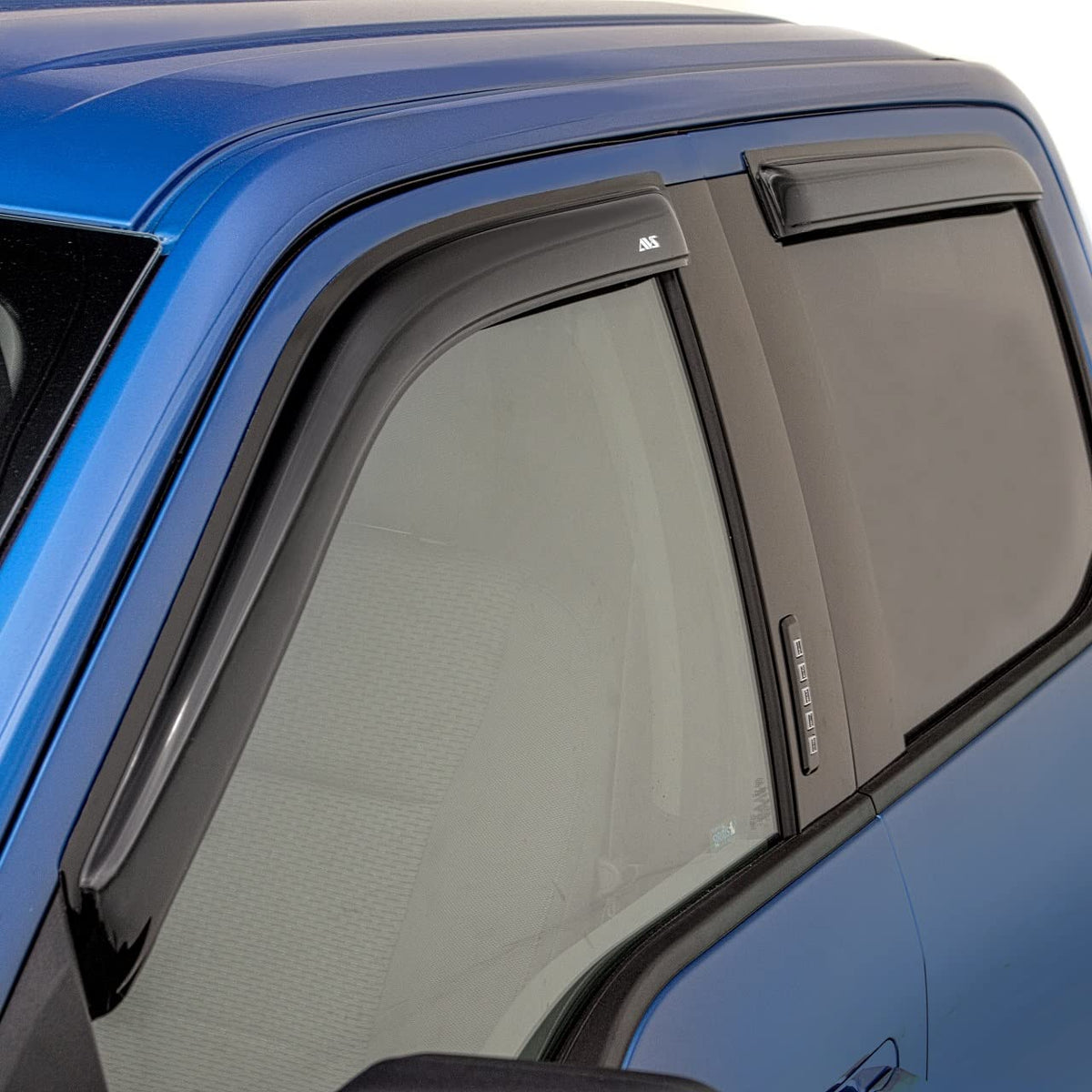 Auto Ventshade ventvisor on parked truck in rain showing ventilation without water intrusion