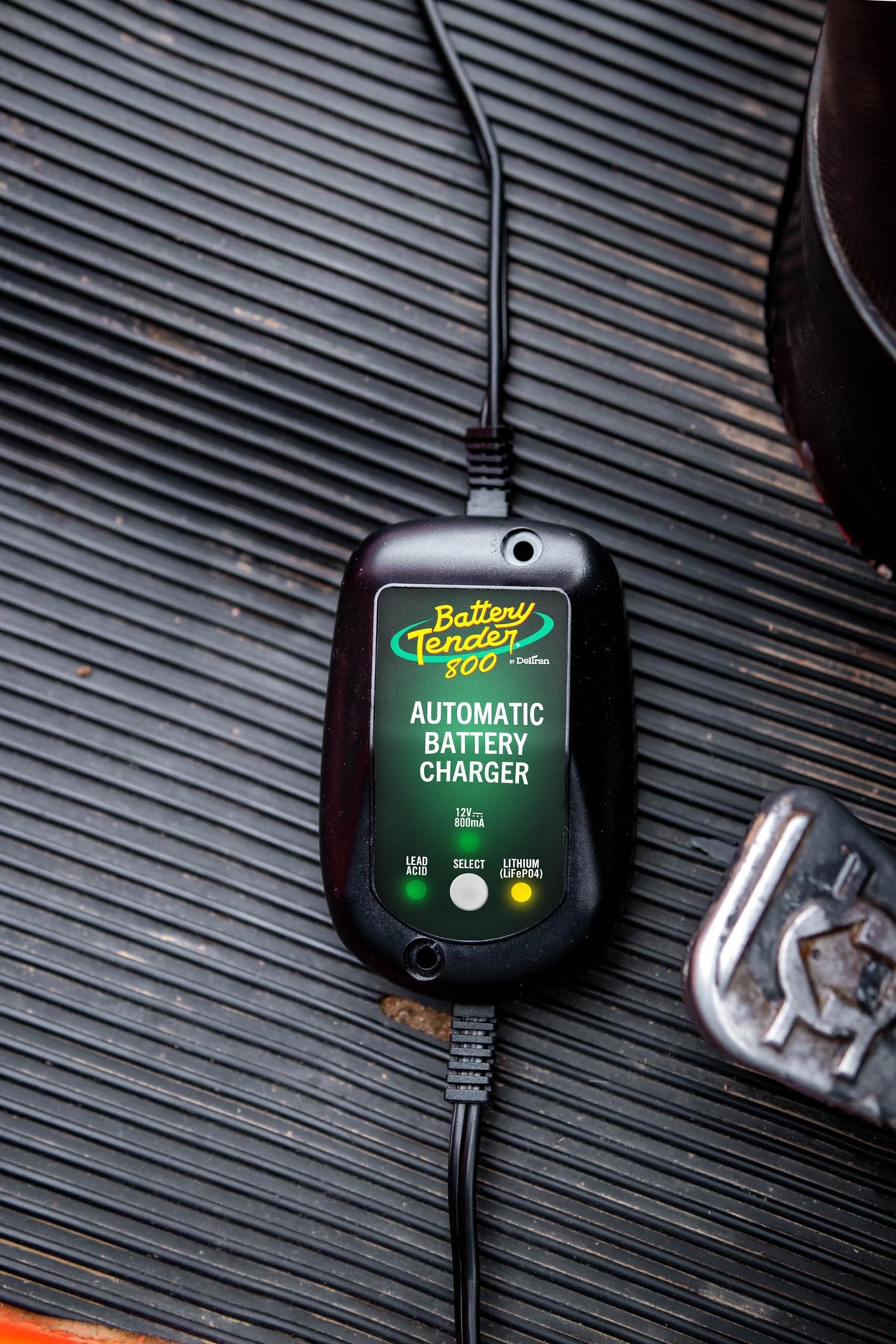 Battery Tender mounted on motorcycle battery showing reliable maintenance benefit
